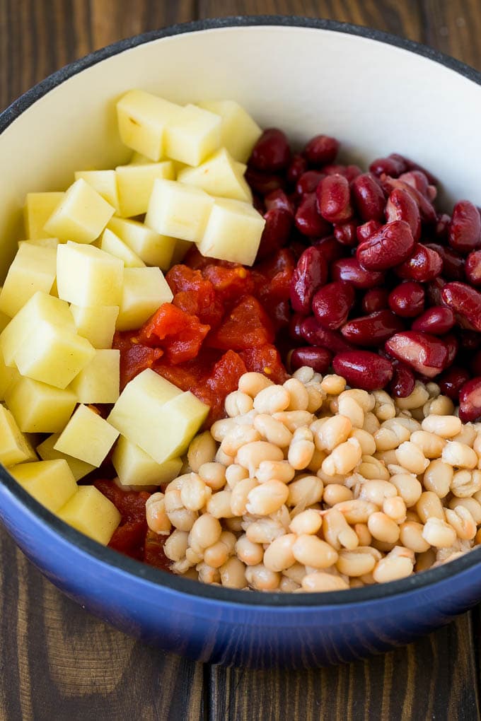 Vegetables, tomatoes, beans and potatoes in a pot.