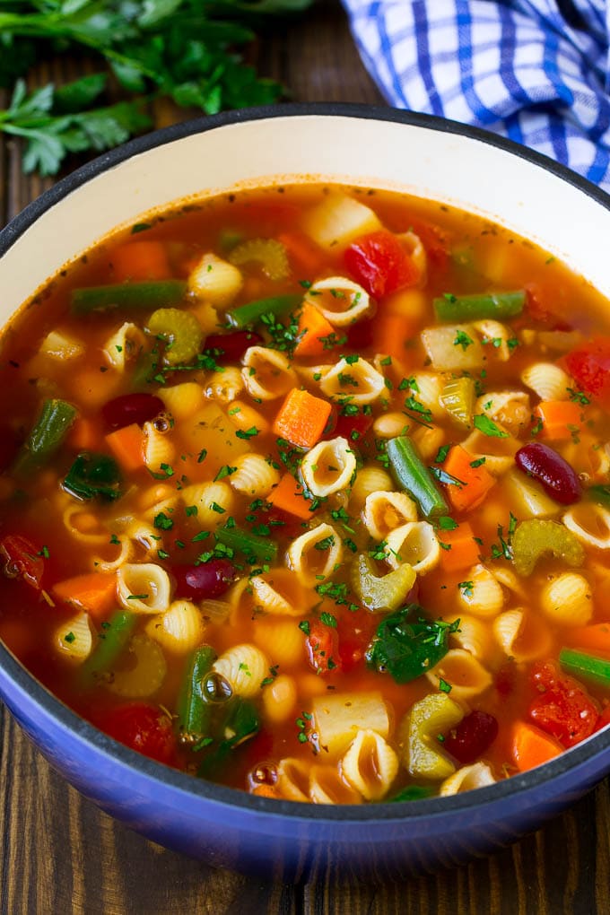 A pot of minestrone soup with vegetables, beans and pasta.