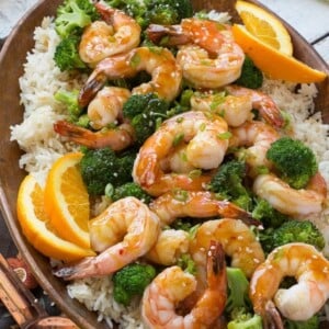 This orange shrimp and broccoli with garlic sesame fried rice is the perfect quick and easy meal for a busy weeknight or for entertaining guests. Ad