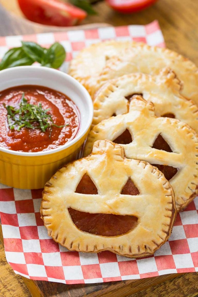 These homemade jack-o-lantern pepperoni pizza pockets are a fun snack for a Halloween party or great to make for dinner before trick-or-treating. Your kids will be thrilled!