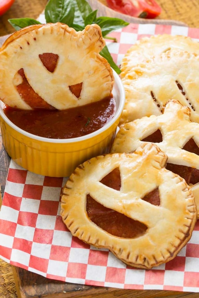 These homemade jack-o-lantern pepperoni pizza pockets are a fun snack for a Halloween party or great to make for dinner before trick-or-treating. Your kids will be thrilled!