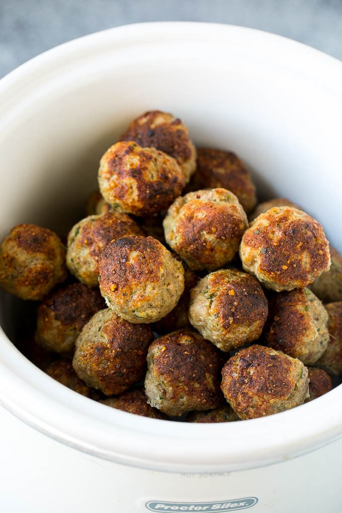 Browned turkey meatballs in a crock pot.