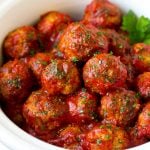 Turkey meatballs in tomato sauce inside a slow cooker.