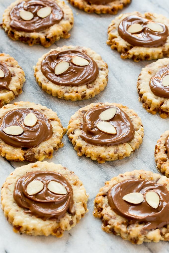 Almond roca cookies topped with melted chocolate.