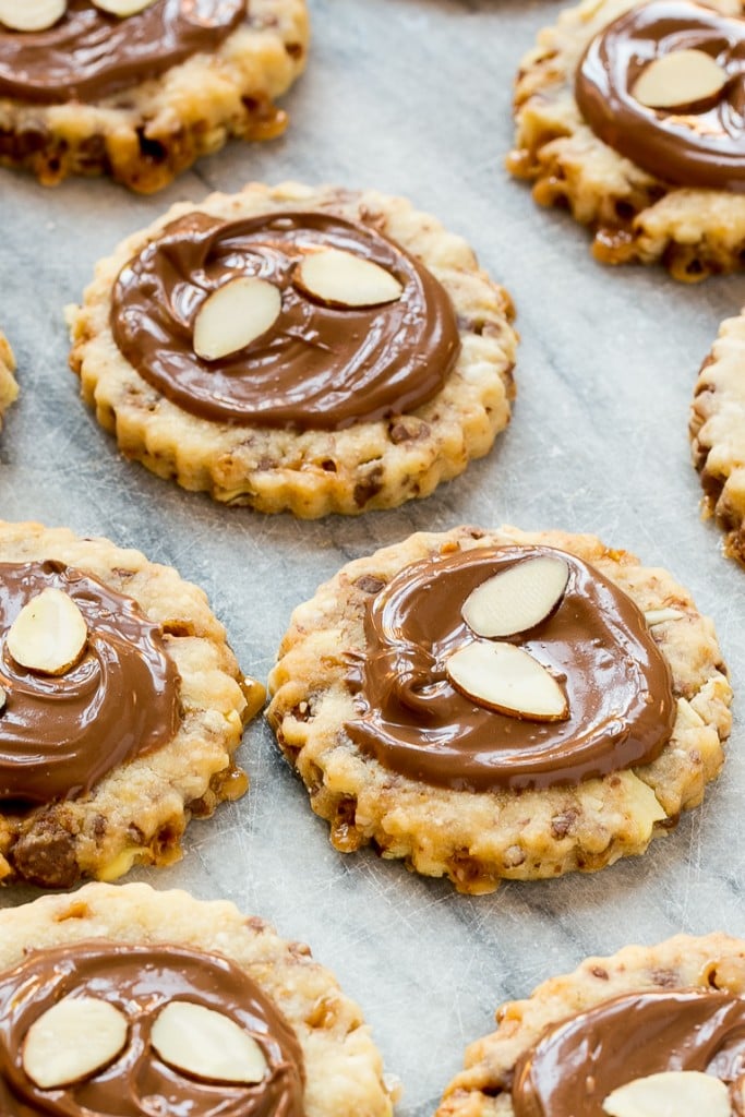 These almond roca cookies are loaded with toffee and almonds and topped with creamy milk chocolate. #BakeMagicMoments #Target ad