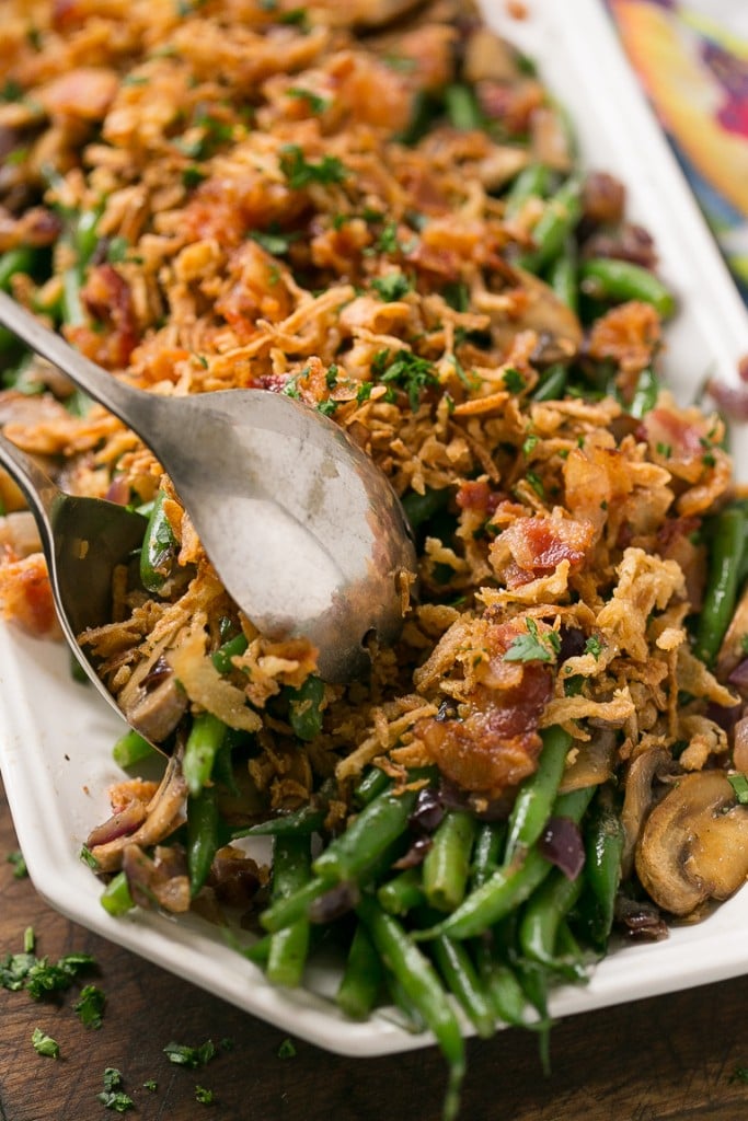 These green beans are cooked in a ranch butter sauce and topped with crispy onions and bacon. SO much better than green bean casserole!