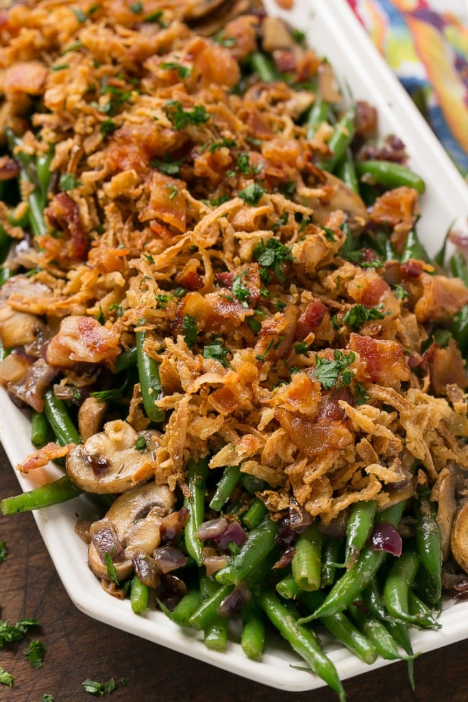 These green beans are cooked in a ranch butter sauce and topped with crispy onions and bacon. SO much better than green bean casserole!