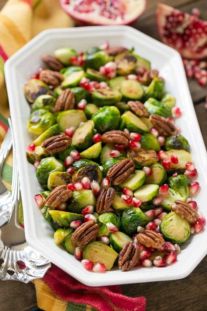 Pomegranate Brussels sprouts with pecans is a serving dish. 