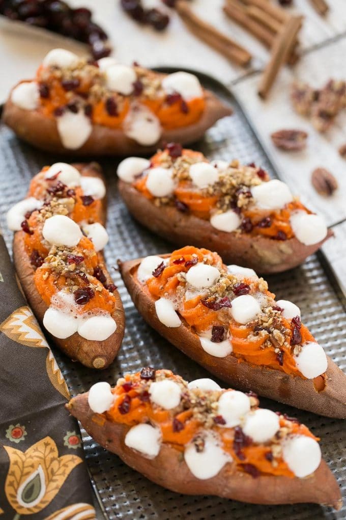 A tray of twice baked sweet potatoes with a streusel topping, marshmallows and dried cranberries. 