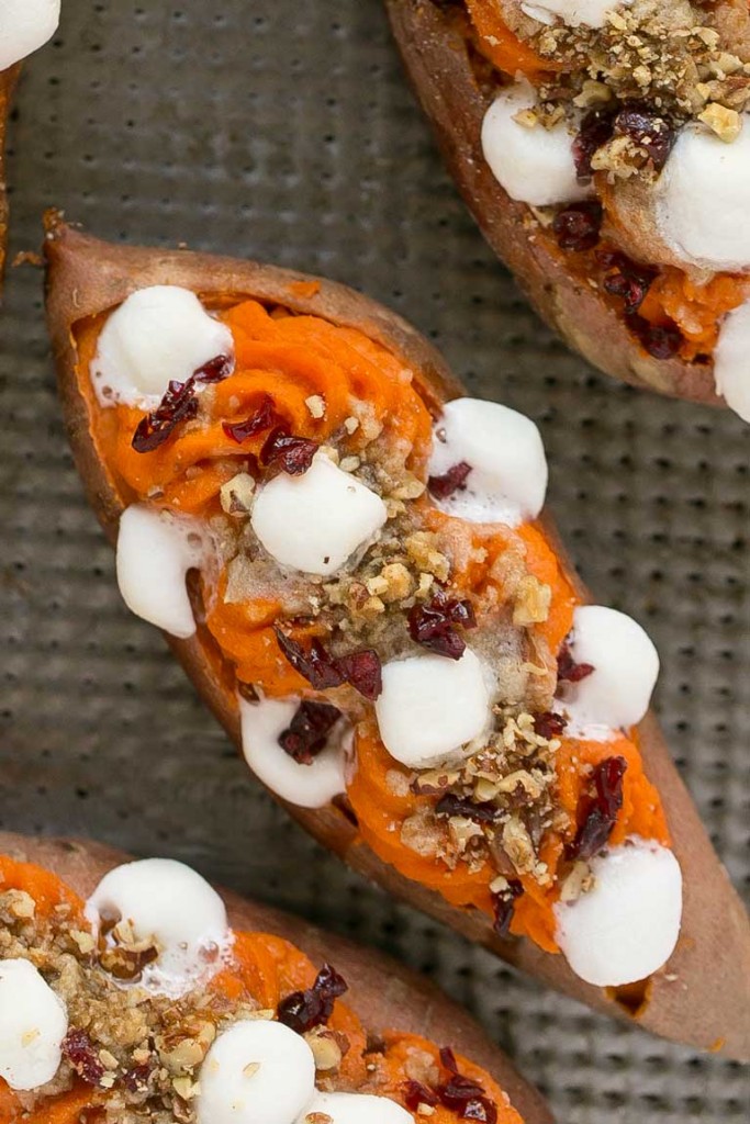 These loaded twice baked sweet potatoes are piled high with pecan brown sugar streusel, marshmallows and dried cranberries. You can prepare them in advance and then pop them in the oven right before your holiday meal!