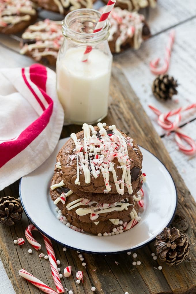 A plate of chocolate peppermint bark cookies with a bottle of milk on the side.