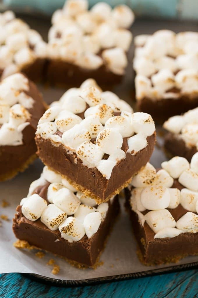 A stack of pieces of S'mores fudge topped with toasted marshmallows.