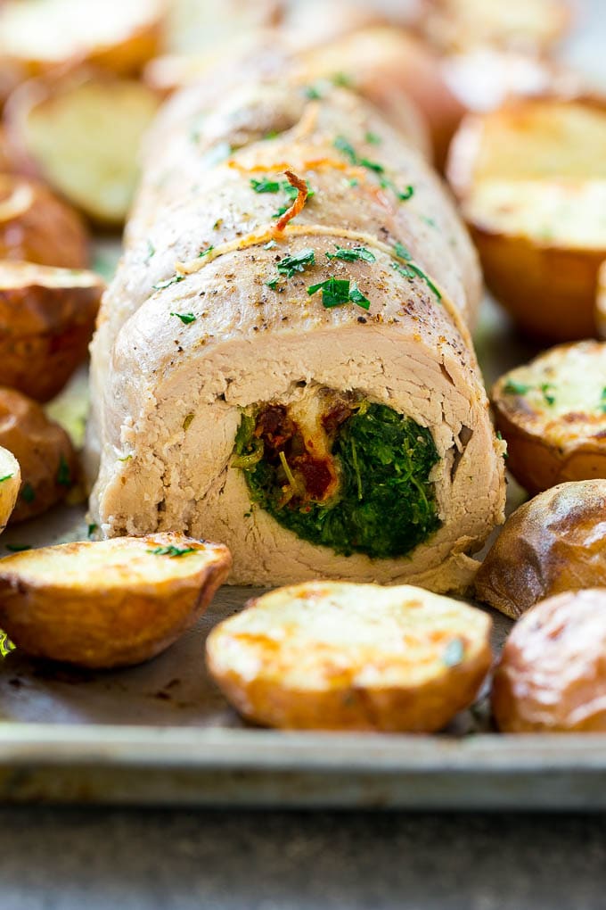 A sliced stuffed pork tenderloin filled with spinach and cheese.