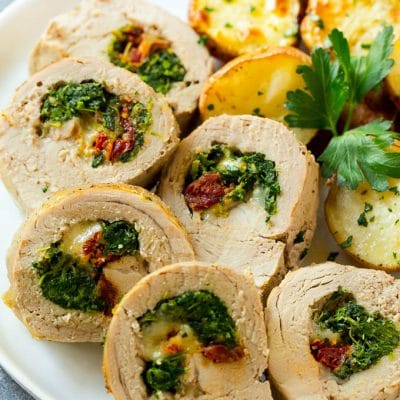 Slices of stuffed pork tenderloin filled with sun dried tomatoes, cheese and spinach.