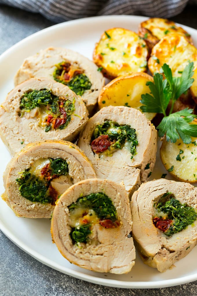 Slices of stuffed pork tenderloin filled with sun dried tomatoes, cheese and spinach.