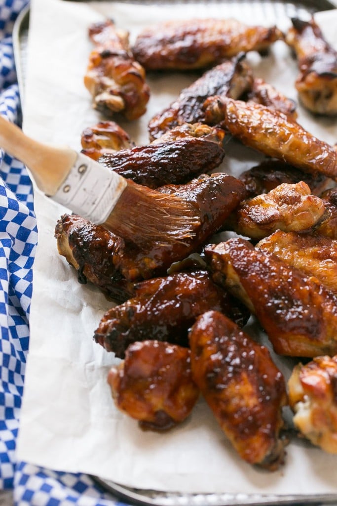 These sweet and tangy baked chicken wings are smothered in a homemade barbecue sauce. They’re extra crispy without any frying required! #OneOfAKindFan #ad
