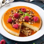 This rich and creamy flan is flavored with vanilla and almonds and is finished off with chopped honey roasted almonds and raspberries. #ad