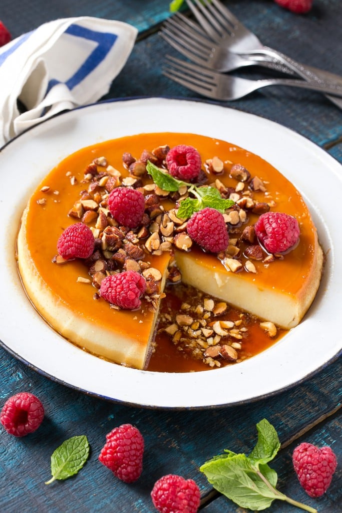 This rich and creamy flan is flavored with vanilla and almonds and is finished off with chopped honey roasted almonds and raspberries.