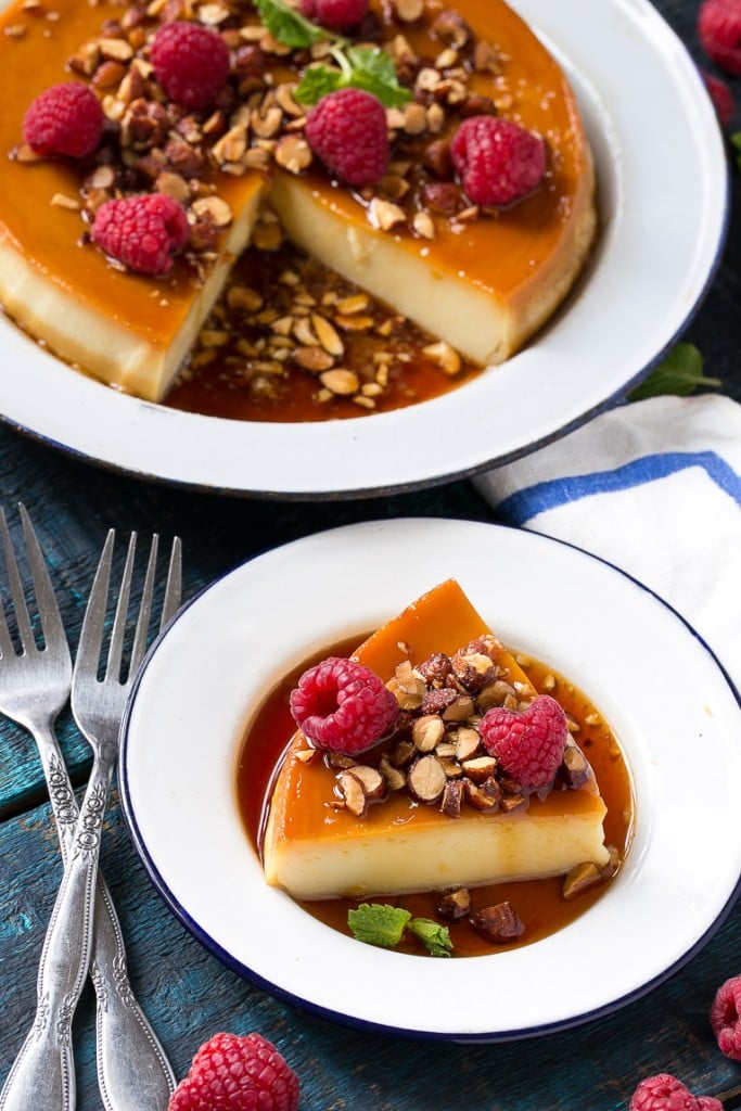 This rich and creamy flan is flavored with vanilla and almonds and is finished off with chopped honey roasted almonds and raspberries.