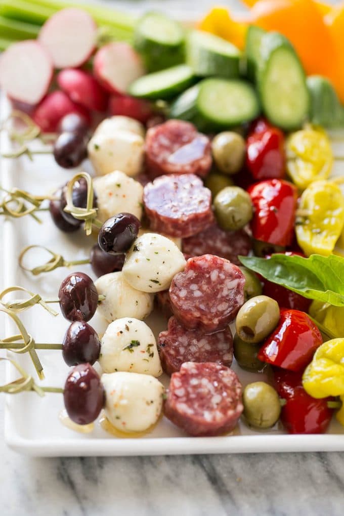 Antipasto skewers on a white serving platter.