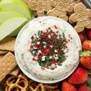 This Christmas cookie dough dip has a fluffy and creamy base that's swirled with plenty of holiday sprinkles and served with fruit and cookies for dipping. It only takes 5 minutes to make! #HolidayWithChobani Ad