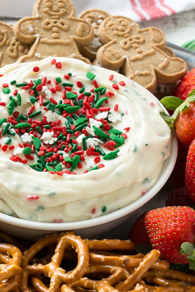 This Christmas cookie dough dip has a fluffy and creamy base that's swirled with plenty of holiday sprinkles and served with fruit and cookies for dipping. It only takes 5 minutes to make! #HolidayWithChobani Ad