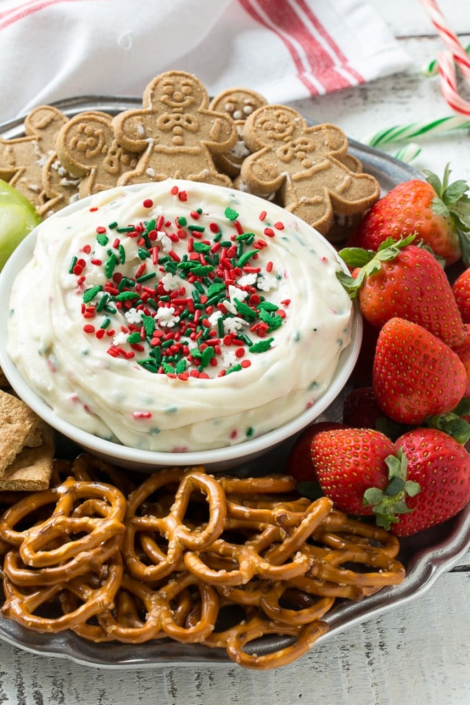 This Christmas cookie dough dip has a fluffy and creamy base that's swirled with plenty of holiday sprinkles and served with fruit and cookies for dipping. It only takes 5 minutes to make! #HolidayWithChobani Ad