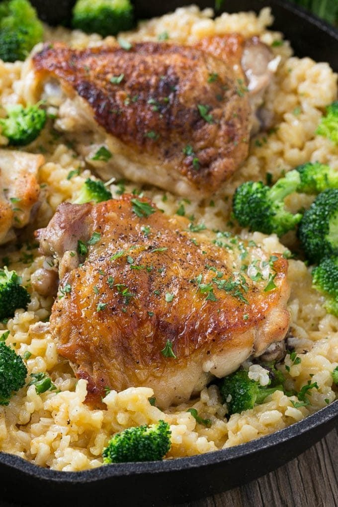 Chicken thighs served over cheesy broccoli rice.