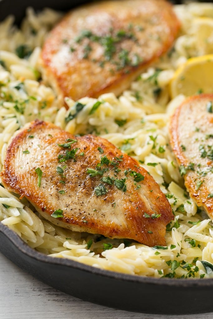 This one pot chicken with creamy spinach artichoke pasta is made with seared chicken breasts, orzo pasta, fresh spinach, artichokes and plenty of cheese. It's a quick and easy weeknight dinner with less dishes to do at the end!