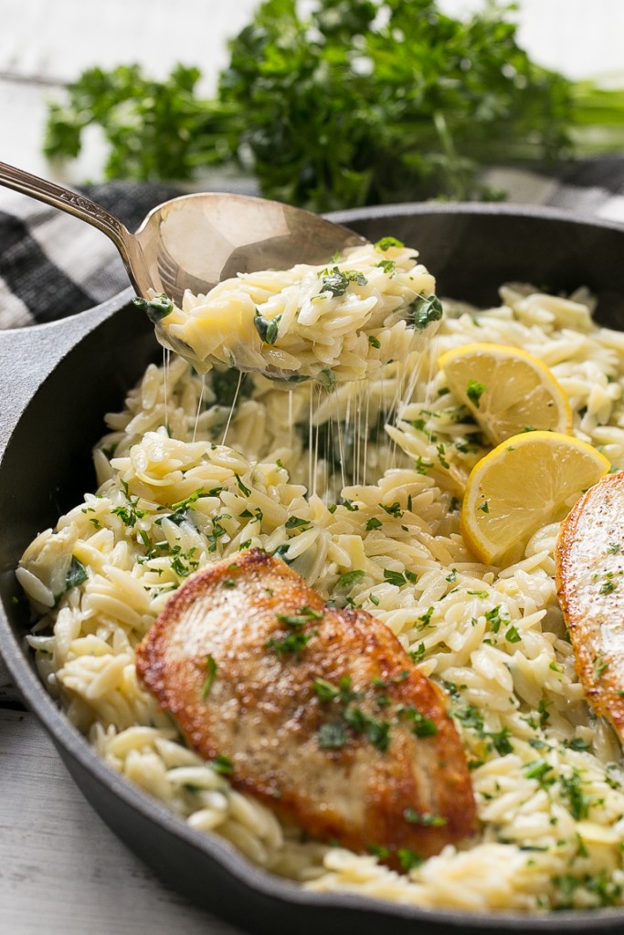This one pot chicken with creamy spinach artichoke pasta is made with seared chicken breasts, orzo pasta, fresh spinach, artichokes and plenty of cheese. It's a quick and easy weeknight dinner with less dishes to do at the end!