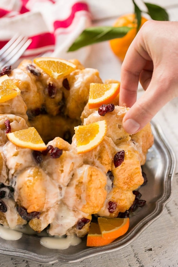 This cranberry orange pull apart monkey bread is balls of soft and tender dough coated in orange sugar and layered with dried cranberries, then baked to a golden brown. It's a lighter alternative to the traditional monkey bread. #BetterWithCraisins Ad