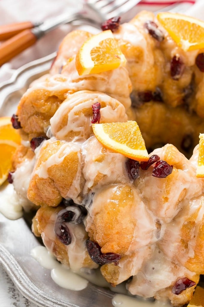 This cranberry orange pull apart monkey bread is balls of soft and tender dough coated in orange sugar and layered with dried cranberries, then baked to a golden brown. It's a lighter alternative to the traditional monkey bread. #BetterWithCraisins Ad