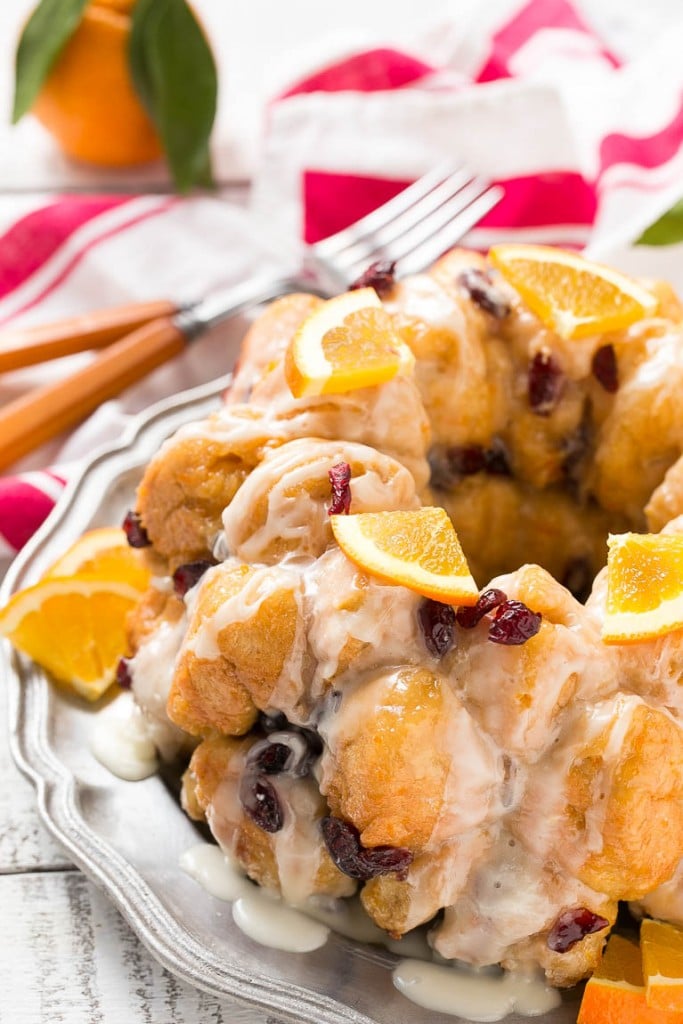 This cranberry orange pull apart monkey bread is balls of soft and tender dough coated in orange sugar and layered with dried cranberries, then baked to a golden brown. It's a lighter alternative to the traditional monkey bread. #BetterWithCraisins Ad