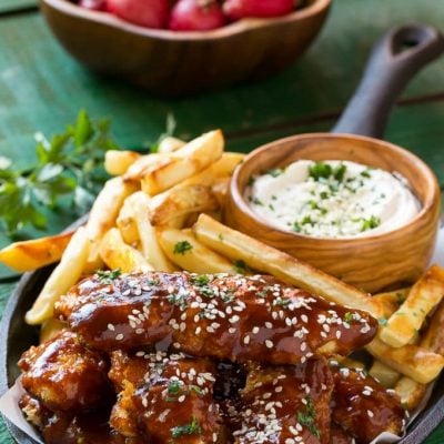 These baked sesame chicken fingers are tossed in a sweet and tangy asian style sauce and are served with fries and a creamy sesame dip. A complete meal in 30 minutes with less guilt! #FarmToFlavor ad