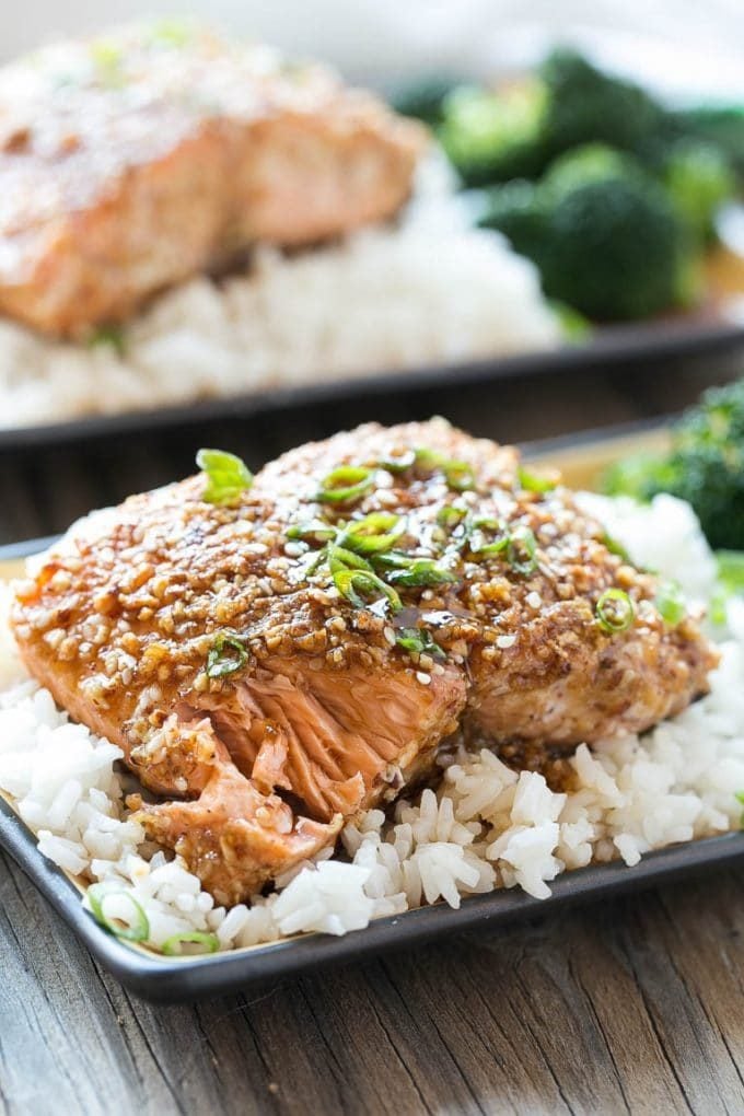 An almond crusted salmon fillet served over white rice.