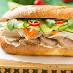This recipe for a bahn mi sandwich starts with a crusty french roll that's then piled high with tender slices of pork, pickled vegetables and fresh herbs for a hearty meal that's full of flavors, colors and textures!