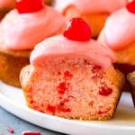 Cherry muffins studded with maraschino cherries and topped with pink glaze.