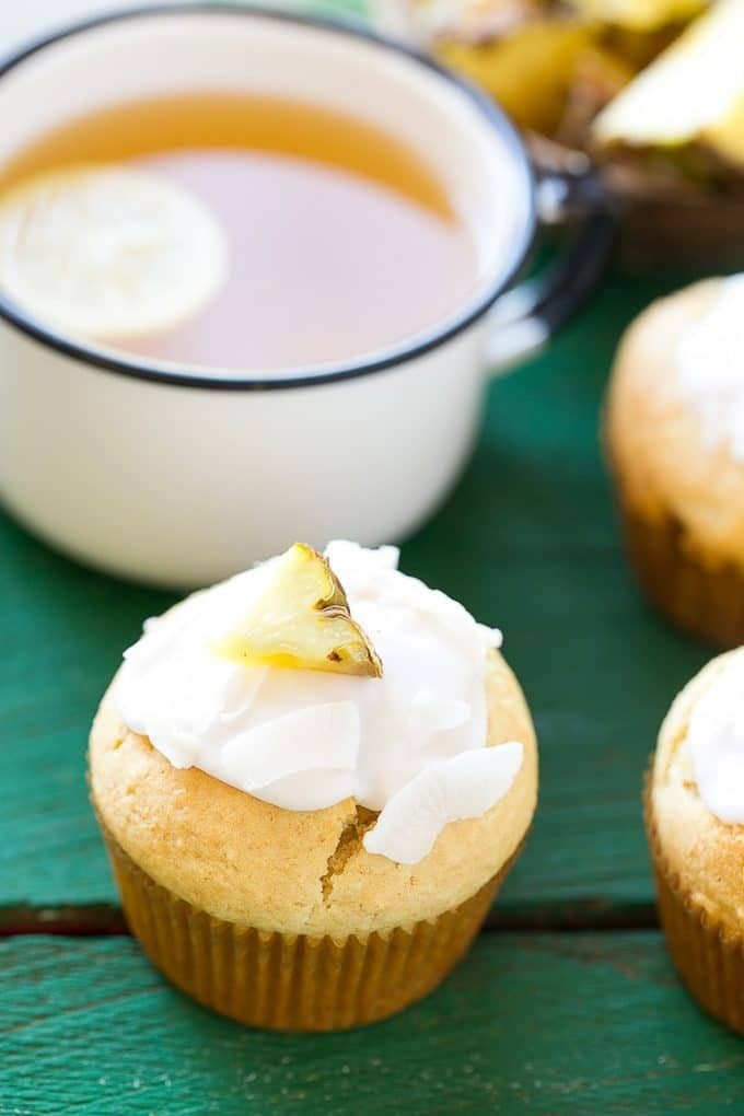 A coconut pineapple muffin topped with glaze.