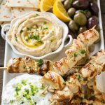 This recipe for greek chicken souvlaki is skewers of tender chicken breast marinated in lemon, garlic and herbs, then grilled to perfection and served with a creamy yogurt sauce. FosterFarmsOrganic AD