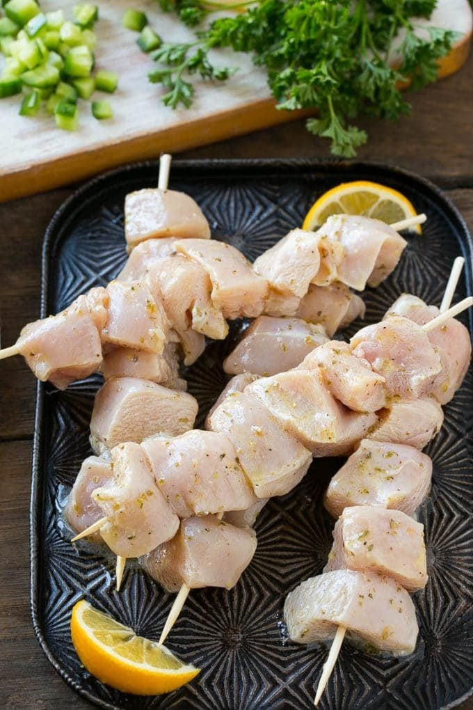 Chunks of marinated chicken breast threaded onto skewers to be grilled.
