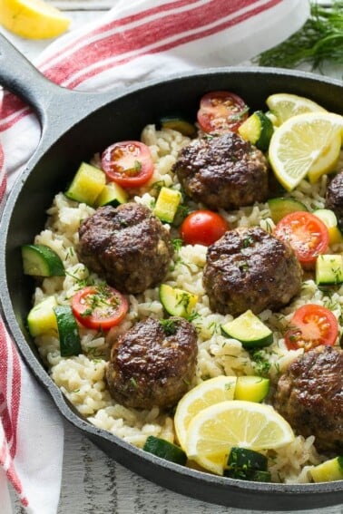 This recipe for one pot greek meatballs with lemon dill rice includes savory greek spiced beef meatballs, creamy arborio rice and vegetables, all cooked together in a single pot! #VillageHarvestInspired