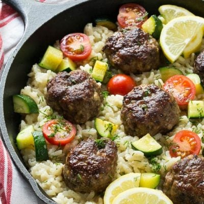 This recipe for one pot greek meatballs with lemon dill rice includes savory greek spiced beef meatballs, creamy arborio rice and vegetables, all cooked together in a single pot! #VillageHarvestInspired