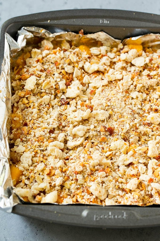 A pan of unbaked peach crumble bars.