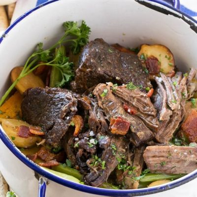This Yankee Pot Roast is a beef roast that's been braised to meltingly tender perfection, seasoned with bacon, and served with potatoes and vegetables. A hearty and comforting meal all in one pot!