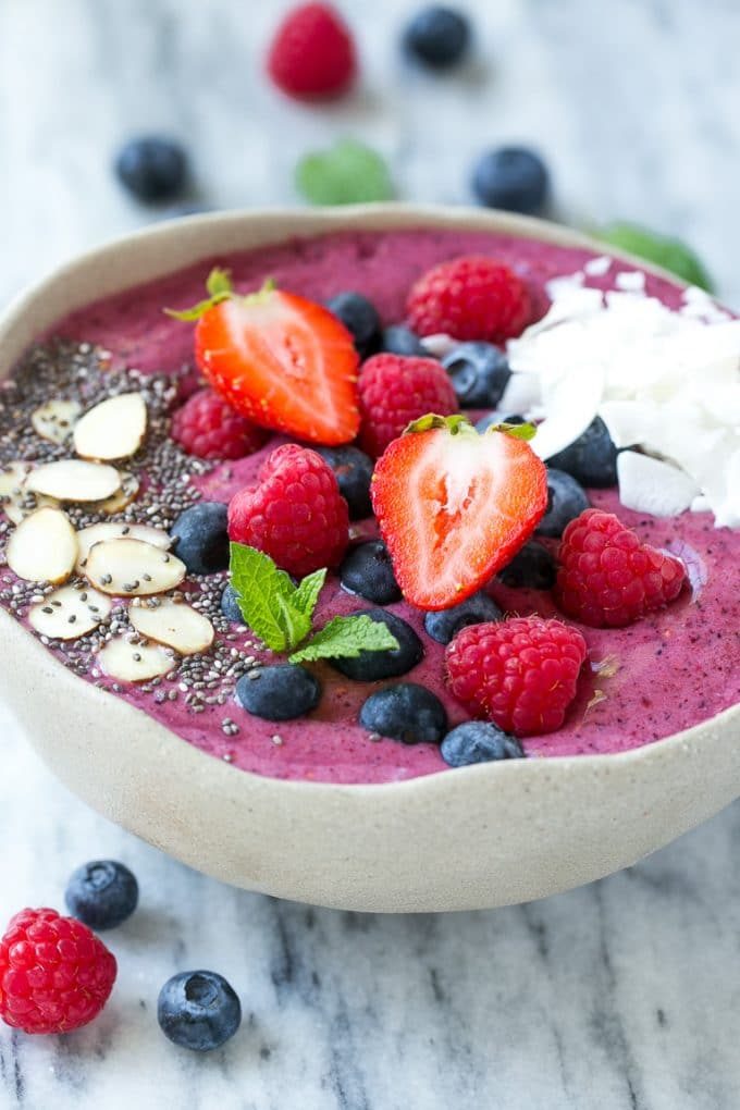 An acai bowl with toppings of fresh strawberries and blueberries.