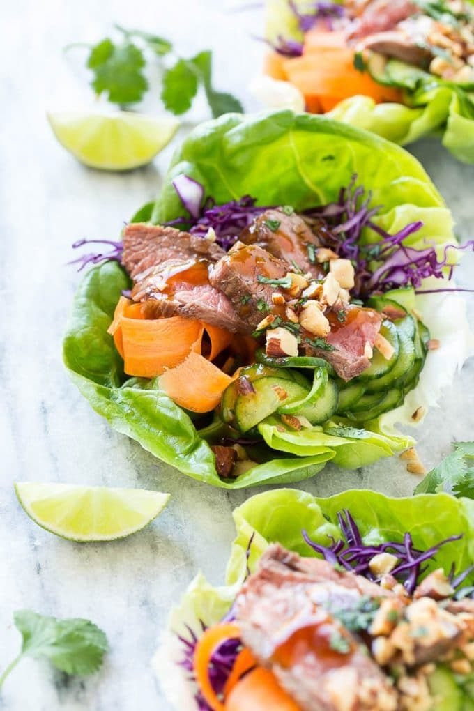 Beef lettuce wraps made with cabbage, pickled cucumbers and seared steak.