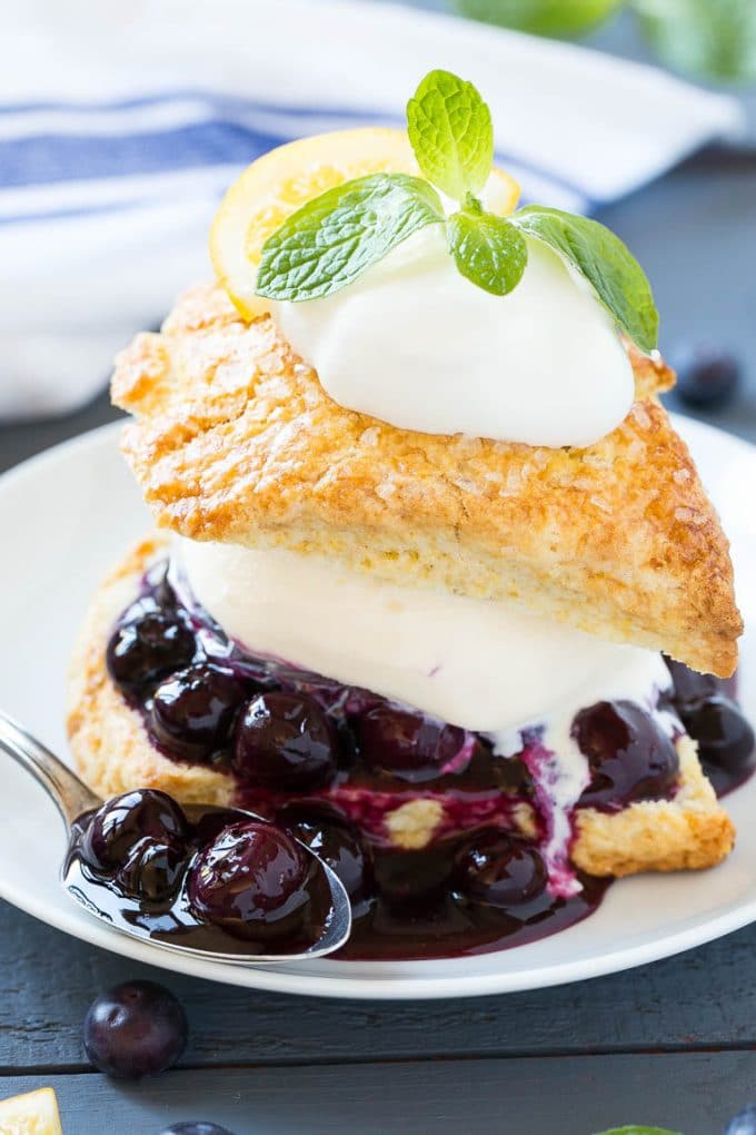 This recipe for blueberry shortcake is vanilla ice cream and homemade blueberry sauce sandwiched between lemon shortcake and finished off with whipped cream. This easy and elegant dessert is perfect for any occasion!