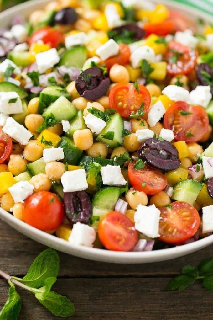 A bowl of Greek salad made with chopped vegetables.