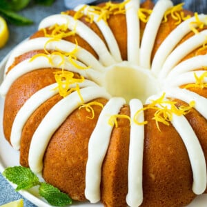 A lemon bundt cake topped with cream cheese frosting and lemon zest.
