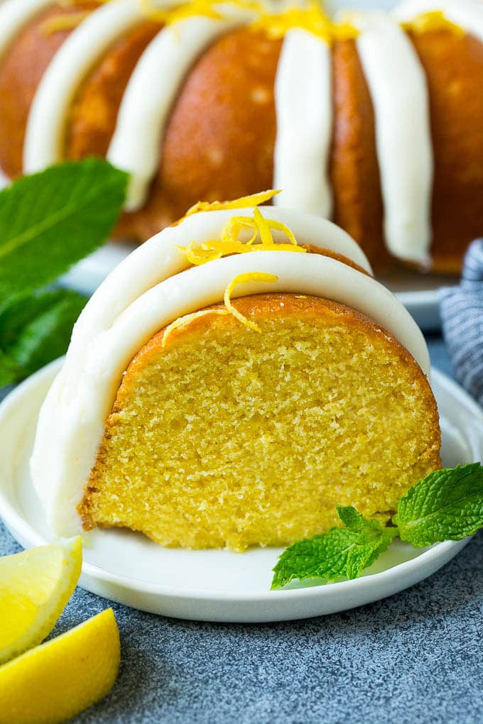 A slice of lemon bundt cake topped with frosting.